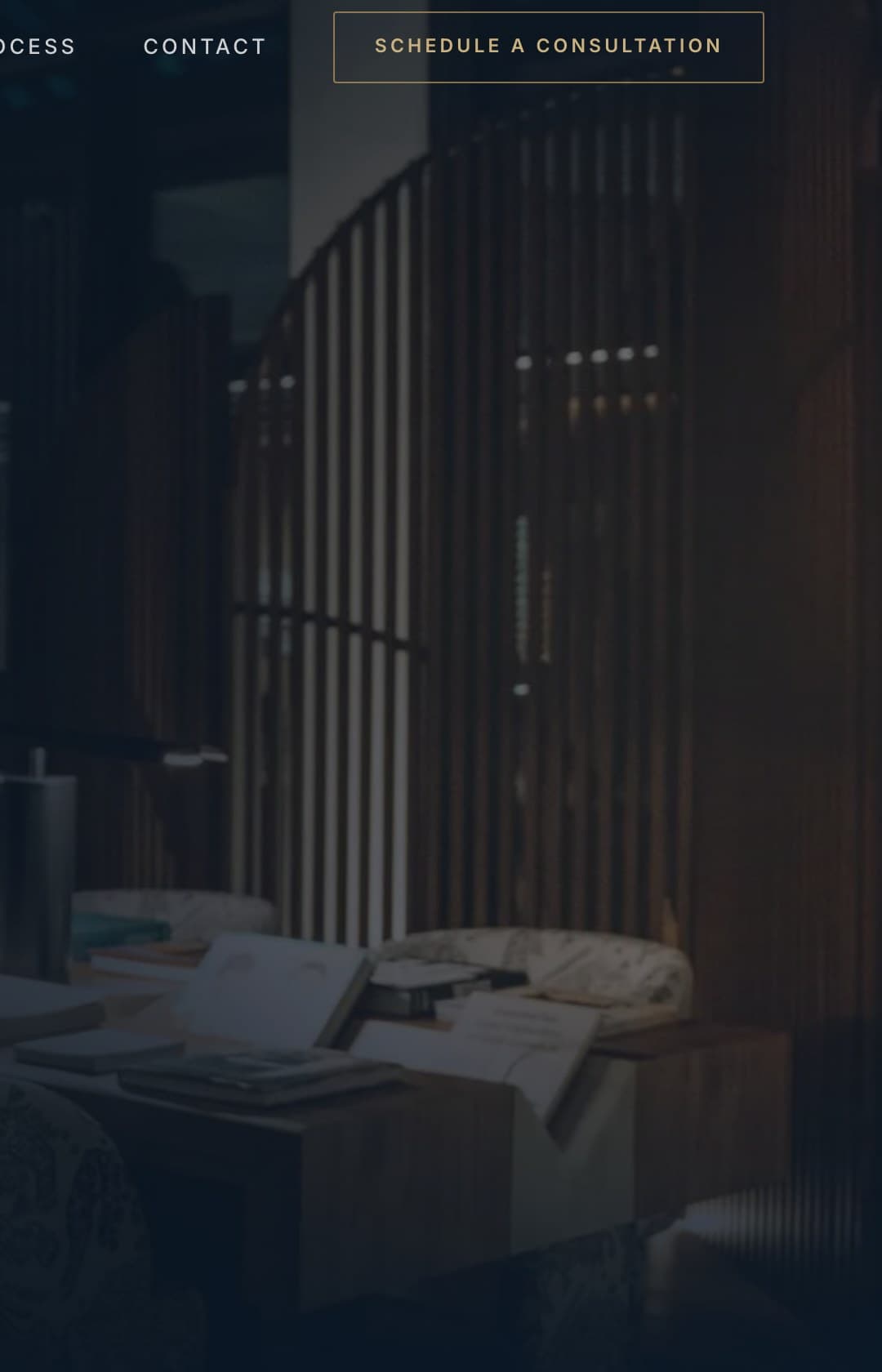 A dark, warmly lit office interior with slatted timber screens and a low table of papers, photographed for the Hudson Associates Wealth website.